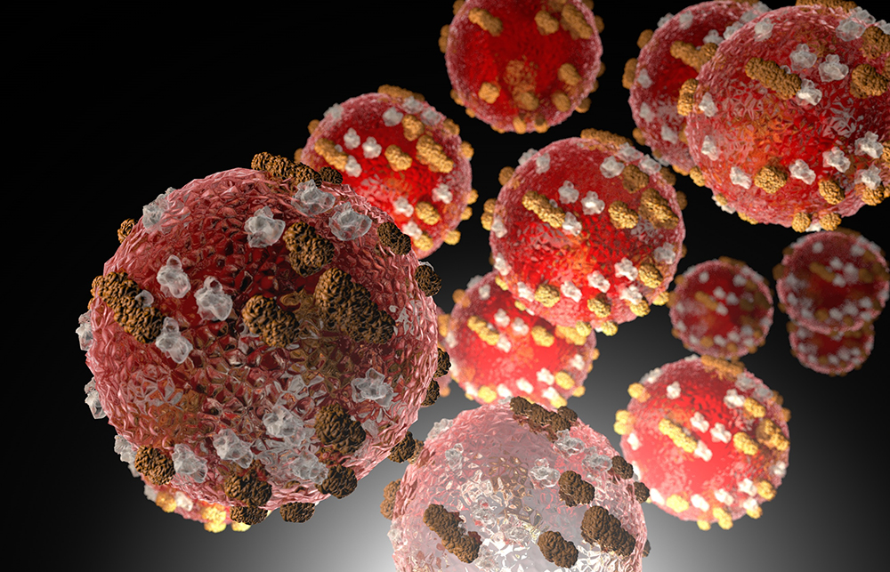 Ilustração de vírus do sarampo, com formas circulares vermelhas, cravejadas de filetes nas cores marrom e amarelo. Créditos: R&A Studio/iStock